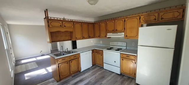 a kitchen with stainless steel appliances granite countertop a refrigerator a stove a sink and a microwave