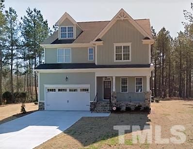 1101 Azadia Court Raleigh, NC 27603 - Photo 1 of 2 a view of a white house with large windows next to a road and large tree