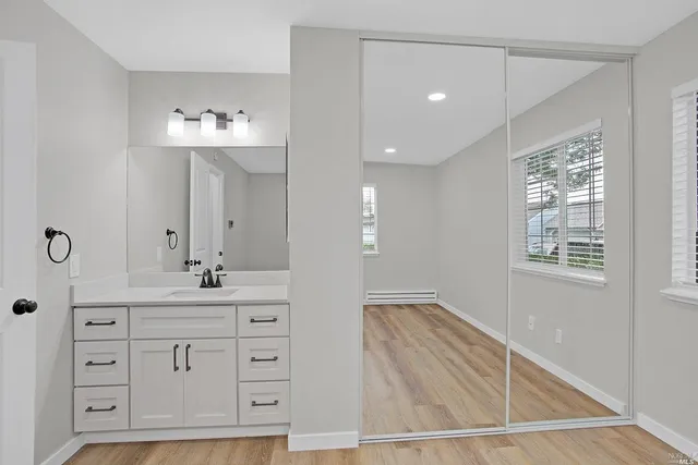 a bathroom with a sink a mirror and shower