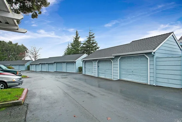 a view of a house with a yard and garage