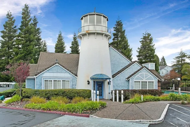 a view of a big house with a big yard and large trees