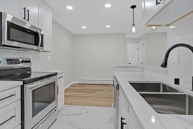 a kitchen with a sink stove and microwave