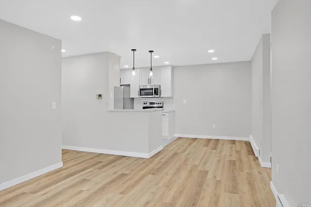 a view of a kitchen with wooden floor