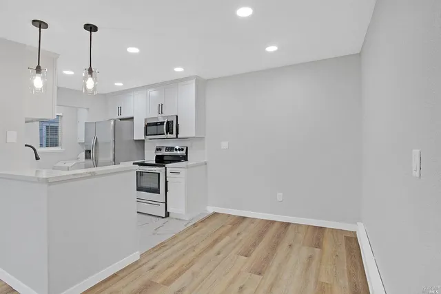 a kitchen with a refrigerator and a sink