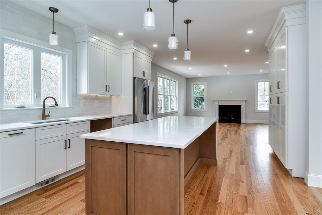 75 Cottage Street Natick, MA 01760 - Photo 12 of 37 a kitchen with counter top space sink and center island