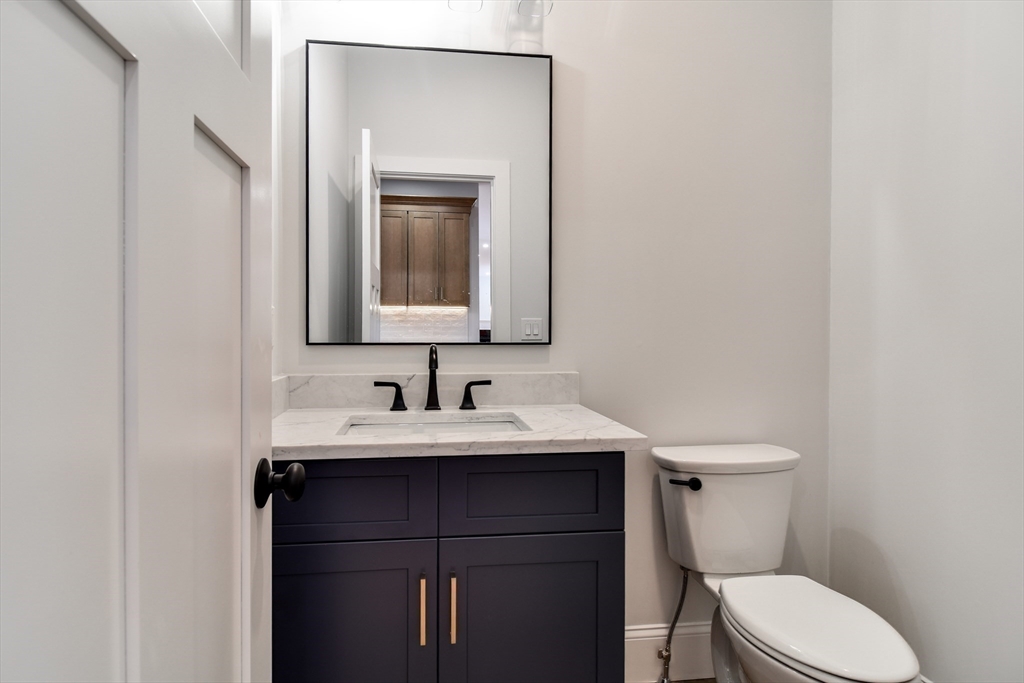 75 Cottage Street Natick, MA 01760 - Photo 15 of 37 a bathroom with a toilet sink and mirror
