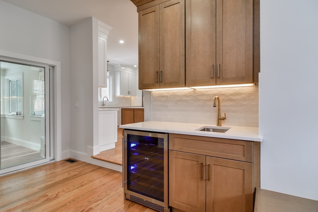 75 Cottage Street Natick, MA 01760 - Photo 16 of 37 a kitchen with a sink cabinets and a wooden floor