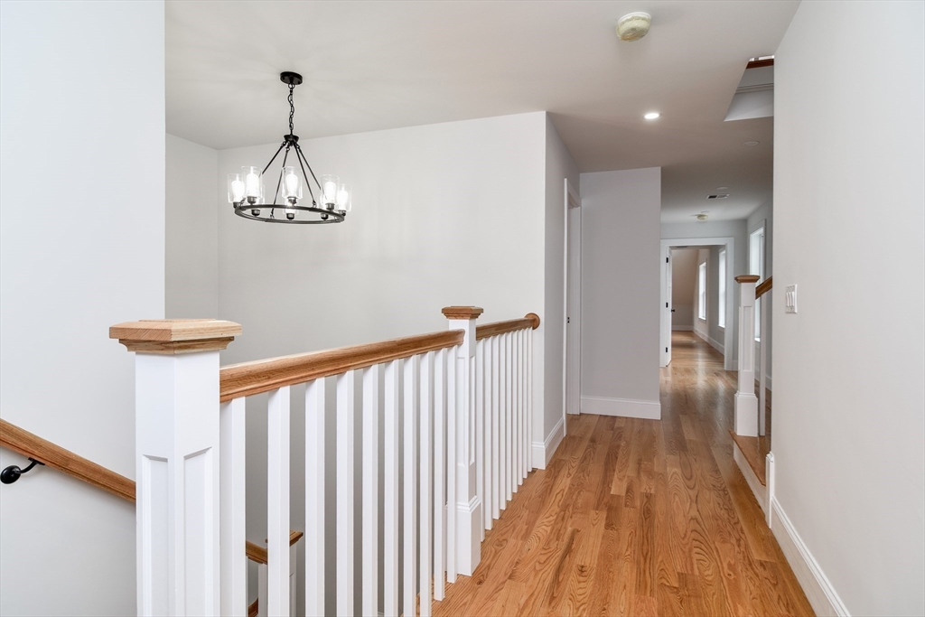75 Cottage Street Natick, MA 01760 - Photo 19 of 37 a view of a hallway with wooden floor