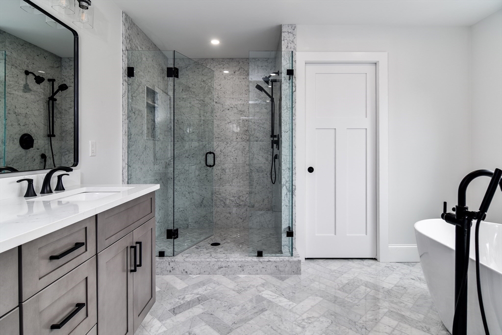 75 Cottage Street Natick, MA 01760 - Photo 22 of 37 a bathroom with a shower sink and mirror