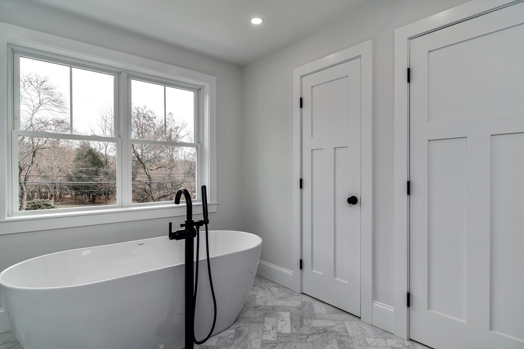 75 Cottage Street Natick, MA 01760 - Photo 23 of 37 a white bath tub sitting next to a window