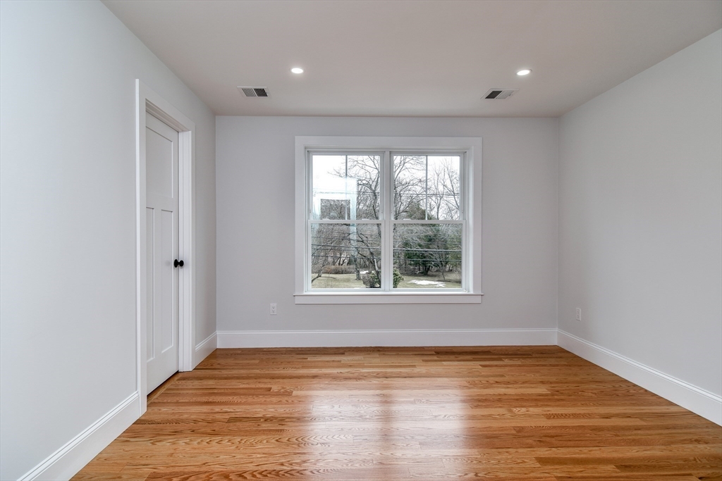 75 Cottage Street Natick, MA 01760 - Photo 25 of 37 a view of an empty room with wooden floor and a window