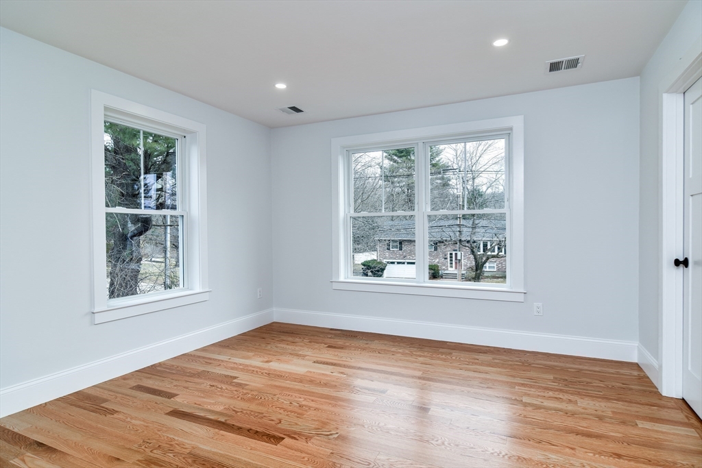 75 Cottage Street Natick, MA 01760 - Photo 27 of 37 an empty room with wooden floor and windows