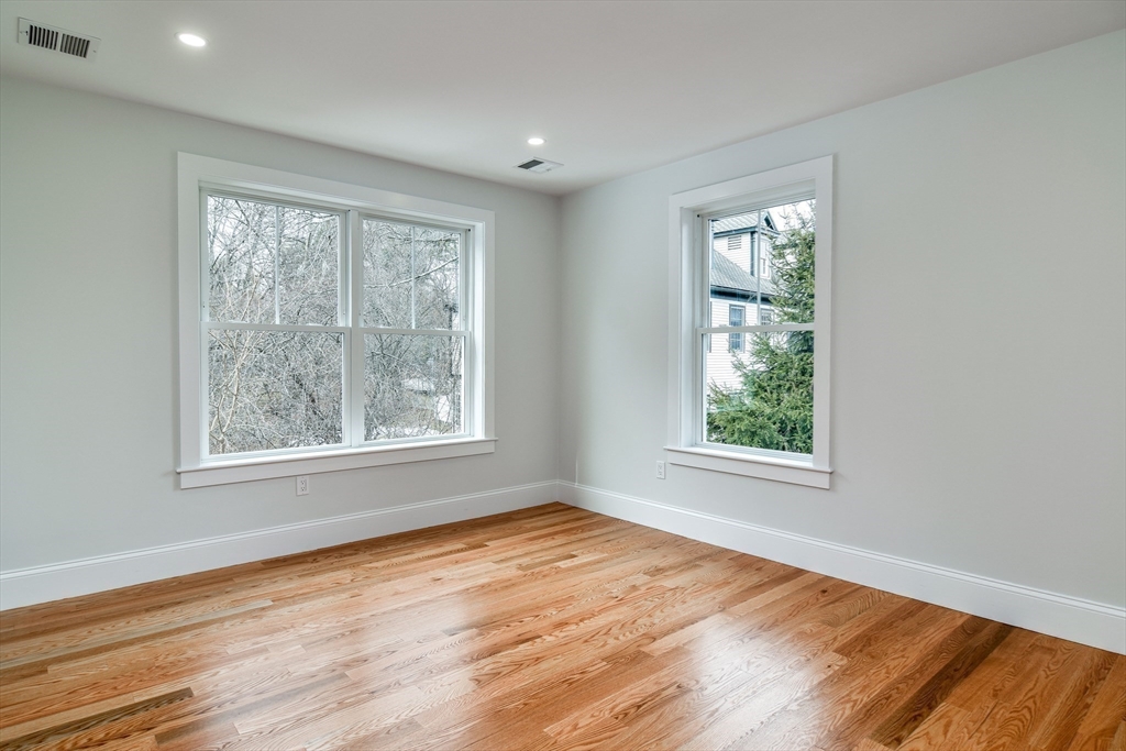 75 Cottage Street Natick, MA 01760 - Photo 28 of 37 a view of an empty room with wooden floor and a window