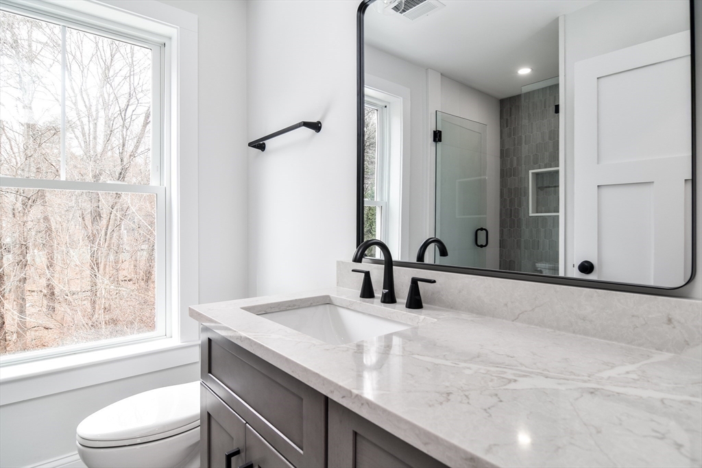 75 Cottage Street Natick, MA 01760 - Photo 29 of 37 a bathroom with a granite countertop sink toilet and shower