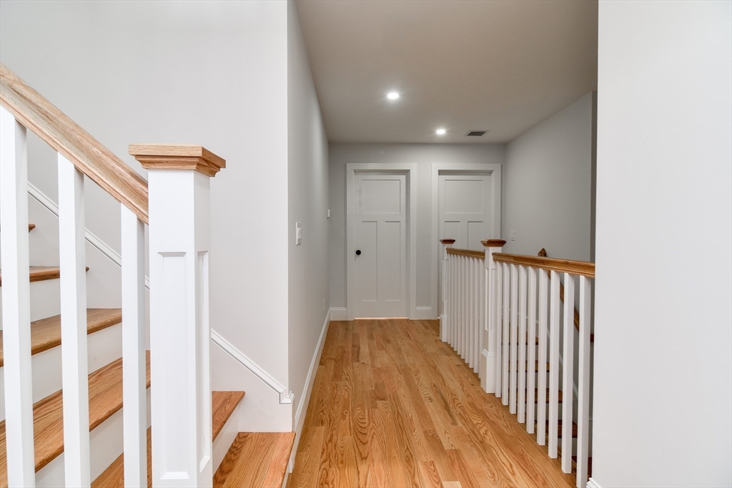 75 Cottage Street Natick, MA 01760 - Photo 30 of 37 a view of a hallway with wooden floor and a bathroom