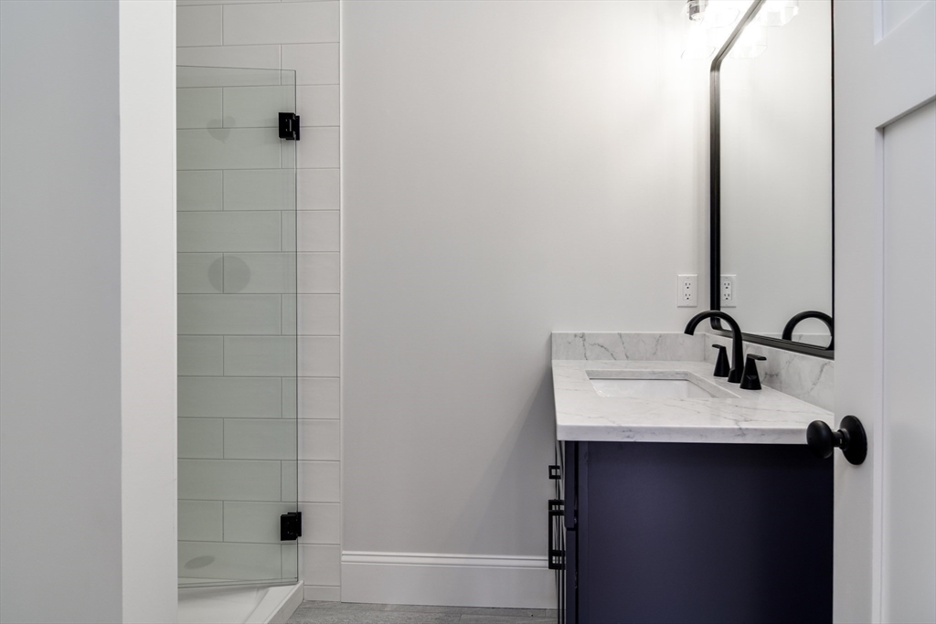 75 Cottage Street Natick, MA 01760 - Photo 34 of 37 a bathroom with a sink and a mirror