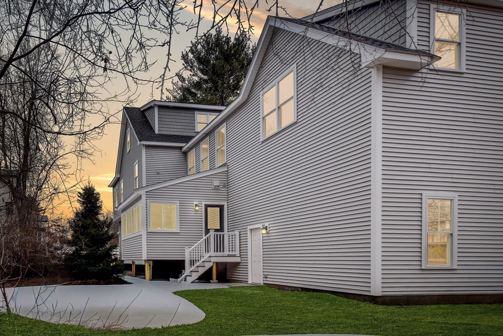 75 Cottage Street Natick, MA 01760 - Photo 35 of 37 a view of a white house next to a yard