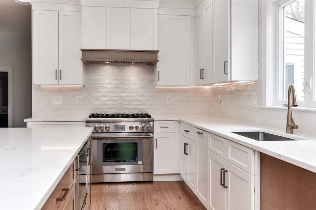 75 Cottage Street Natick, MA 01760 - Photo 8 of 37 a kitchen with granite countertop a stove sink and cabinets