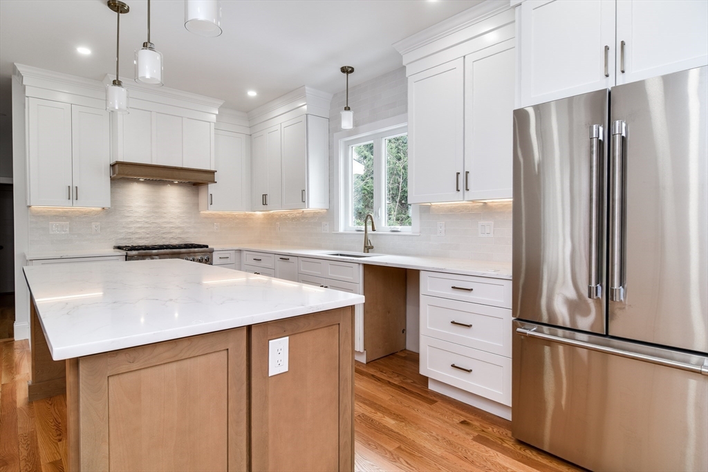 75 Cottage Street Natick, MA 01760 - Photo 9 of 37 a kitchen with a refrigerator a sink and cabinets