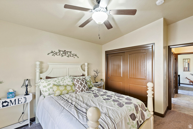 210 Talon Court Ivins, UT 84738 - Photo 41 of 60 Bedroom featuring dark carpet, lofted ceiling, a closet, and a ceiling fan