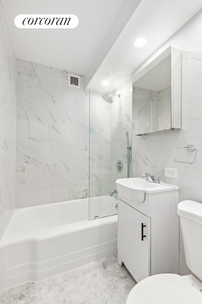 145 East 15th Street, Unit 2D Manhattan, NY 10003 - Photo 6 of 6 a bathroom with a sink a toilet and a bathtub