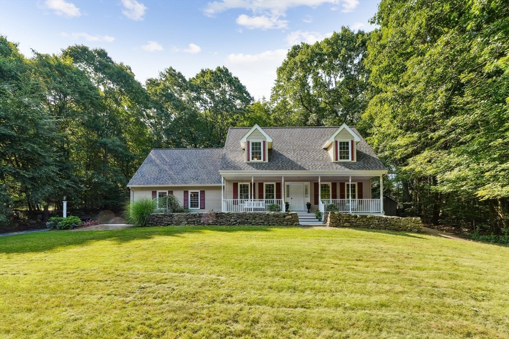a front view of a house with swimming pool and porch