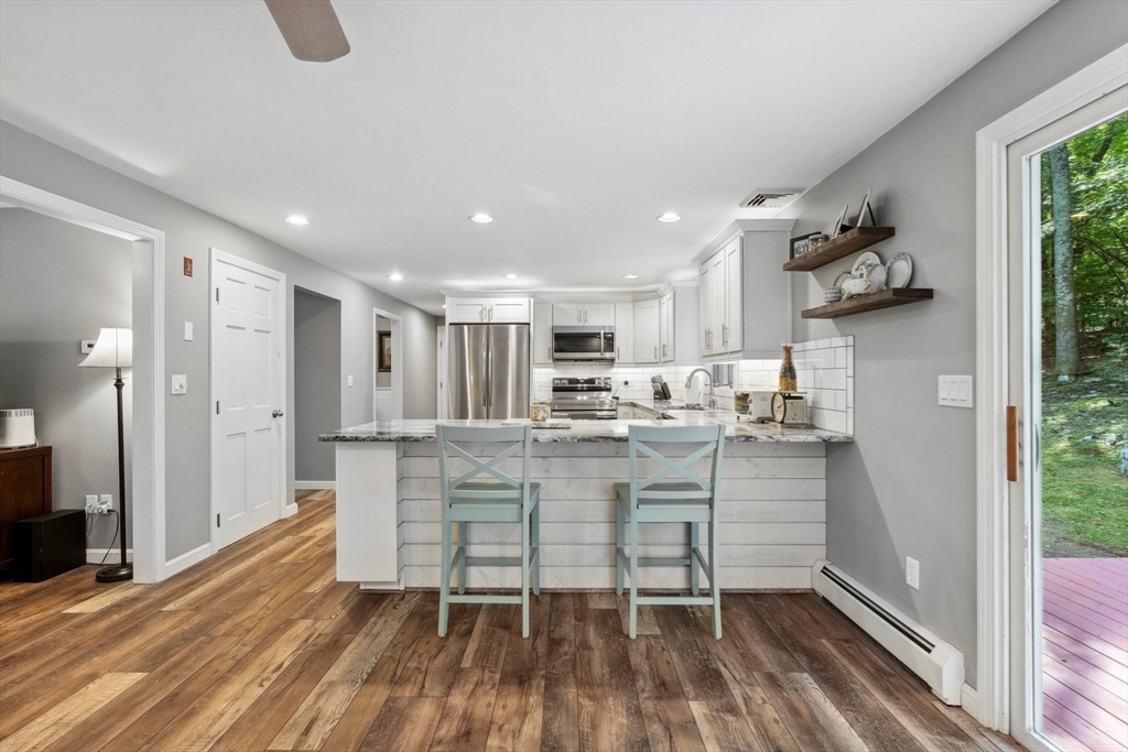 66 Dodge Road Sutton, MA 01590 - Photo 11 of 38 a kitchen with stainless steel appliances granite countertop a stove and a refrigerator