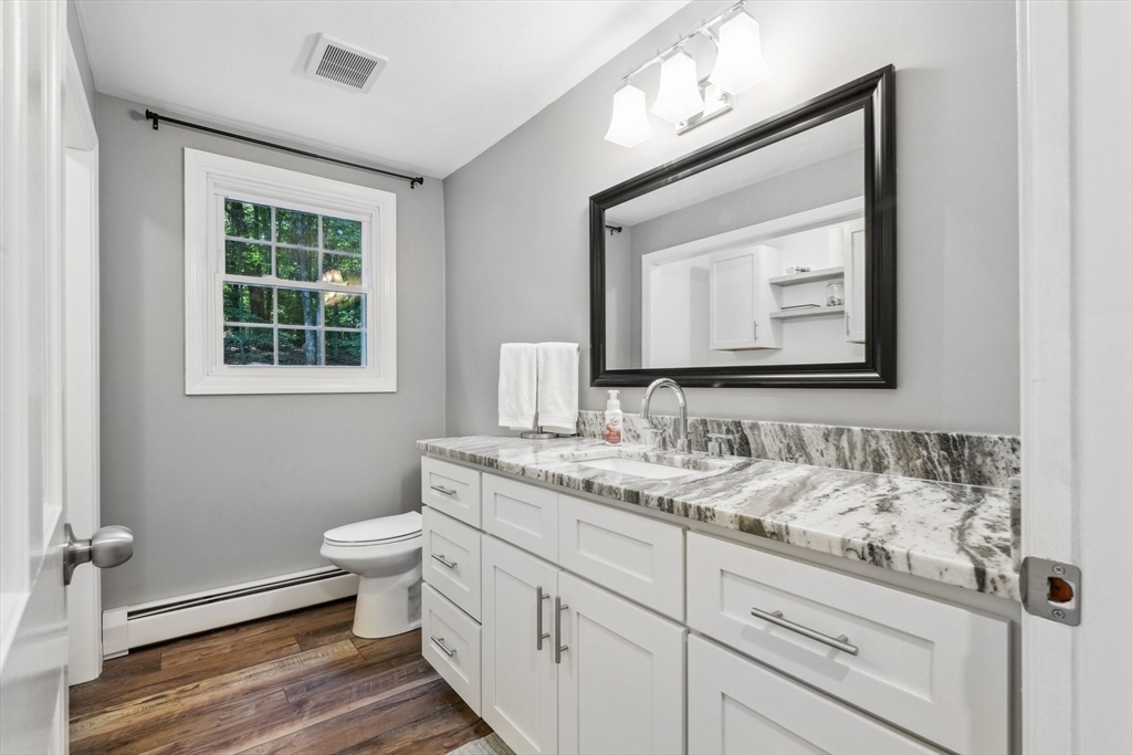66 Dodge Road Sutton, MA 01590 - Photo 14 of 38 a bathroom with a toilet sink and mirror