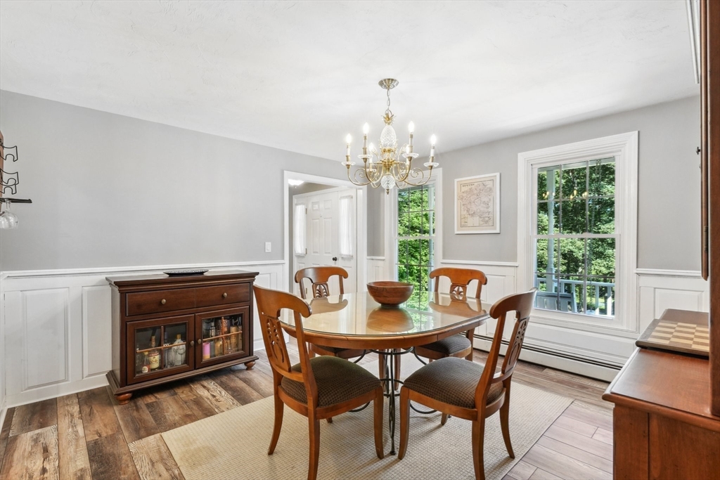 66 Dodge Road Sutton, MA 01590 - Photo 17 of 38 a view of a dining room with furniture a chandelier and wooden floor