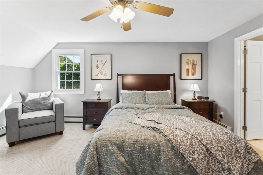 66 Dodge Road Sutton, MA 01590 - Photo 19 of 38 a bedroom with a large bed and a chandelier