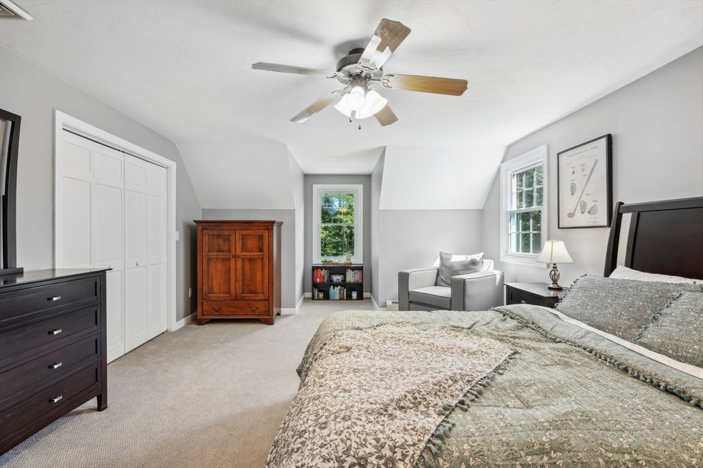 66 Dodge Road Sutton, MA 01590 - Photo 20 of 38 a bedroom with a bed couches and a flat tv screen