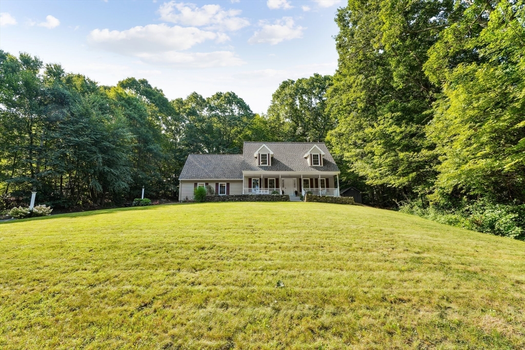 66 Dodge Road Sutton, MA 01590 - Photo 2 of 38 a big pool with some trees in the background