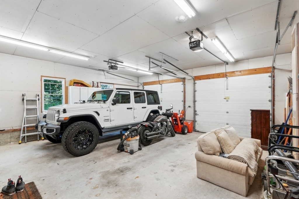 66 Dodge Road Sutton, MA 01590 - Photo 27 of 38 a garage with a couch and a large window