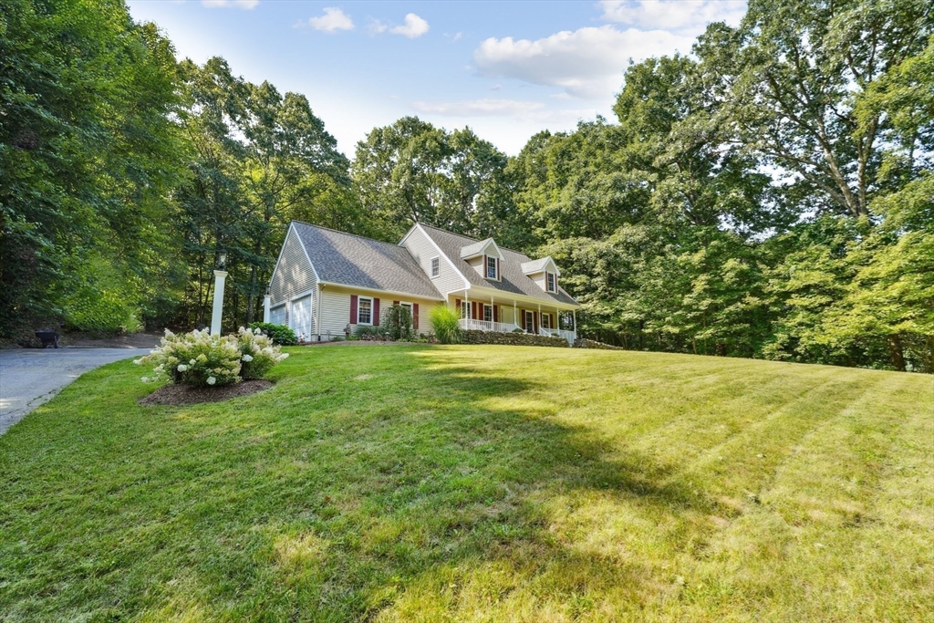 66 Dodge Road Sutton, MA 01590 - Photo 28 of 38 a front view of a house with a garden
