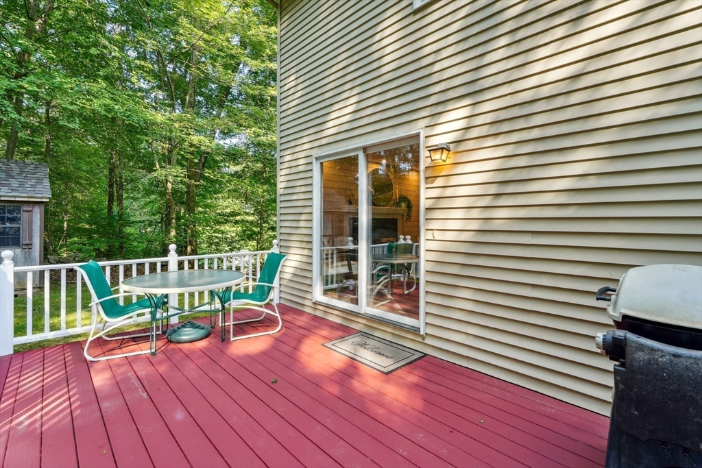 66 Dodge Road Sutton, MA 01590 - Photo 32 of 38 a view of a chair and table on the deck