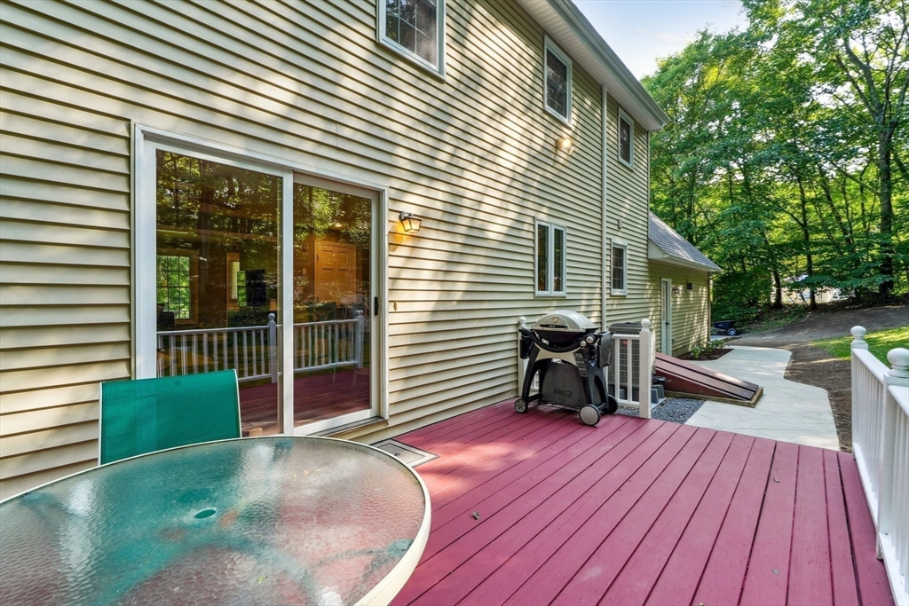 66 Dodge Road Sutton, MA 01590 - Photo 33 of 38 a view of a deck with couches table and chairs and wooden floor