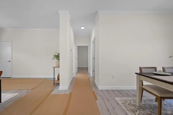a view of a hallway to a livingroom with furniture