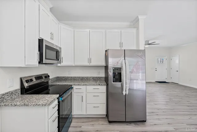 a kitchen with cabinets appliances and a counter space