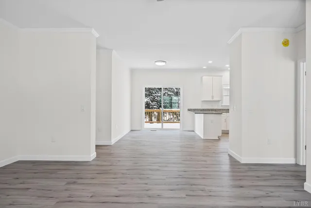 a view of kitchen with wooden floor and electronic appliances
