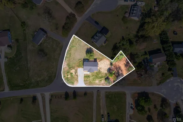 an aerial view of a house with a swimming pool table and chairs