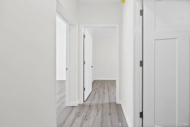 a view of a hallway with wooden floor