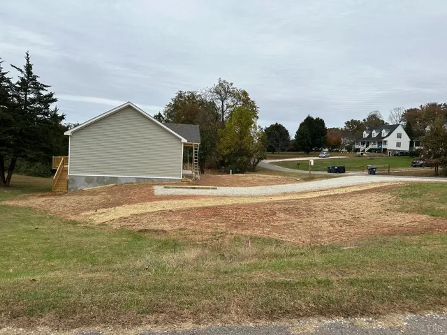a view of an house with a yard and garage