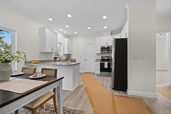 a kitchen with kitchen island stainless steel appliances a sink stove and refrigerator