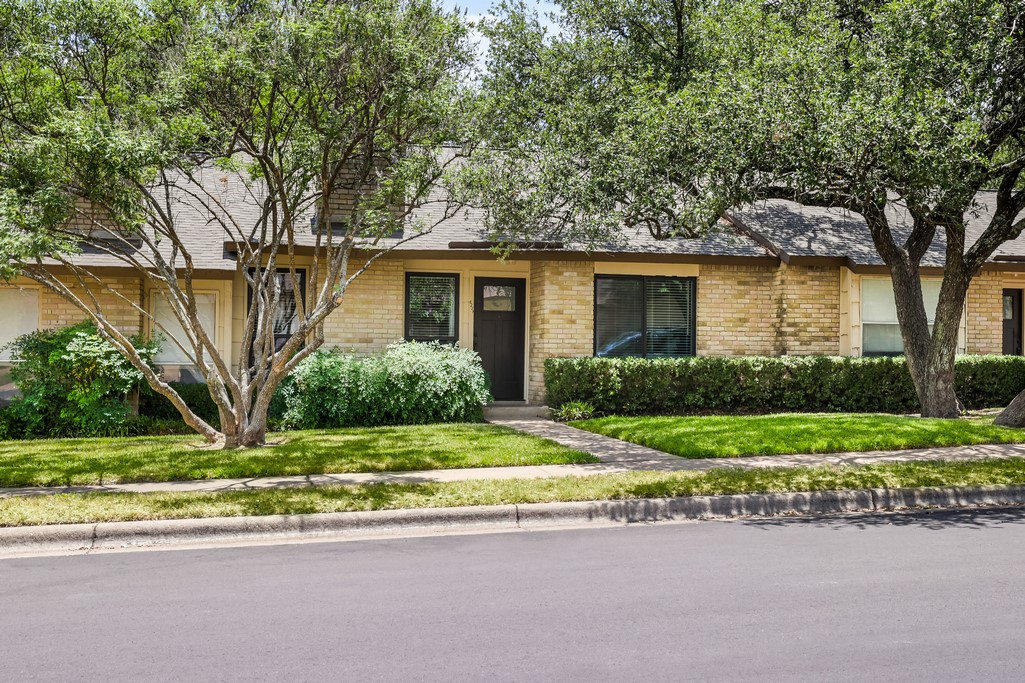 8229 Summer Side Drive Austin, TX 78759 - Photo 1 of 1 a front view of a house with a yard and potted plants
