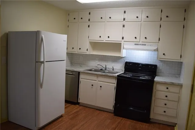a white refrigerator freezer sitting inside of a kitchen