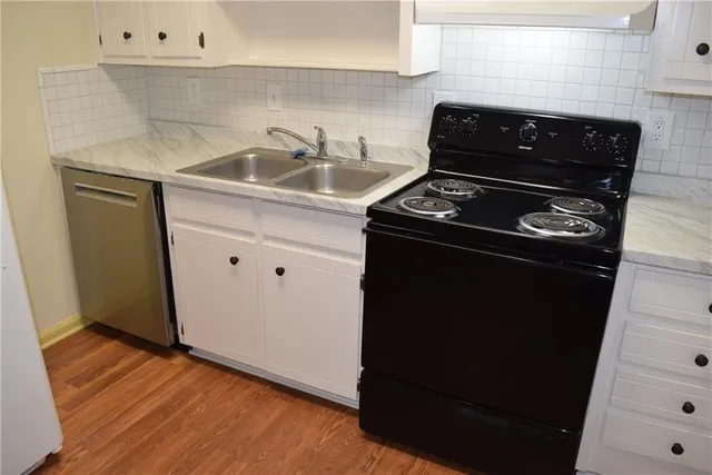 a close view of a stove a microwave and sink
