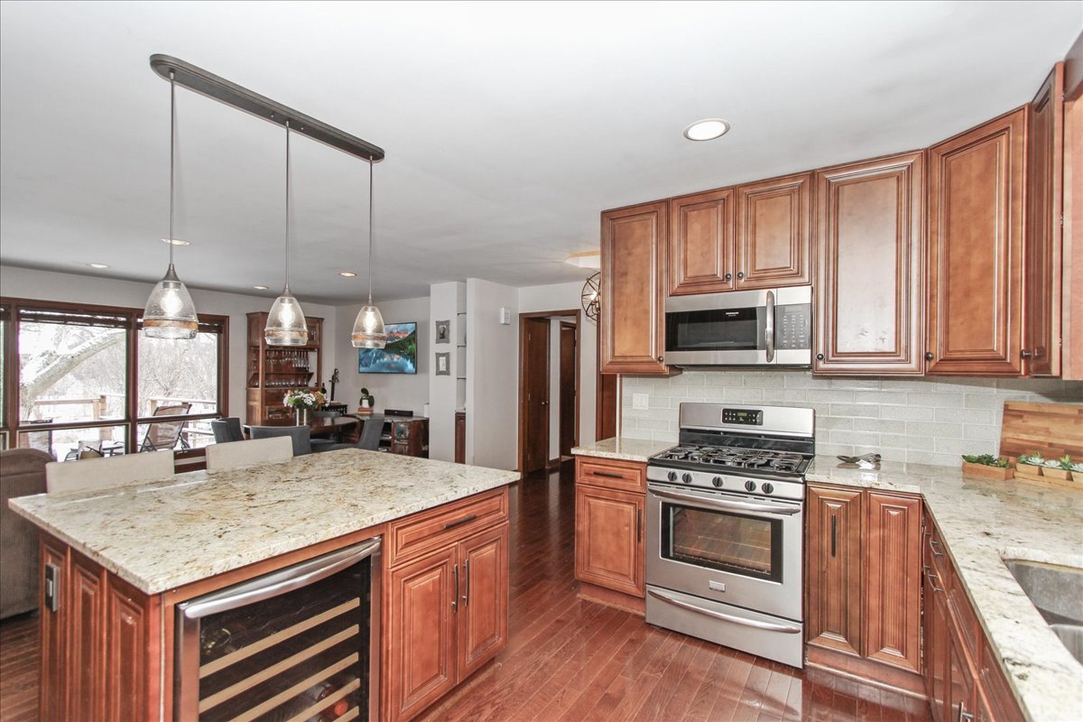 1865 Kevin Avenue Elgin, IL 60123 - Photo 18 of 48 a kitchen with stainless steel appliances kitchen island granite countertop a stove sink and cabinets