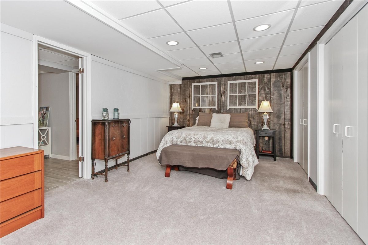 1865 Kevin Avenue Elgin, IL 60123 - Photo 34 of 48 a bed room with a bed and a chair