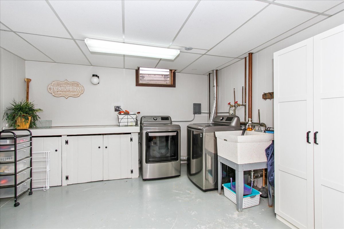 1865 Kevin Avenue Elgin, IL 60123 - Photo 38 of 48 a utility room with cabinets dryer and washer