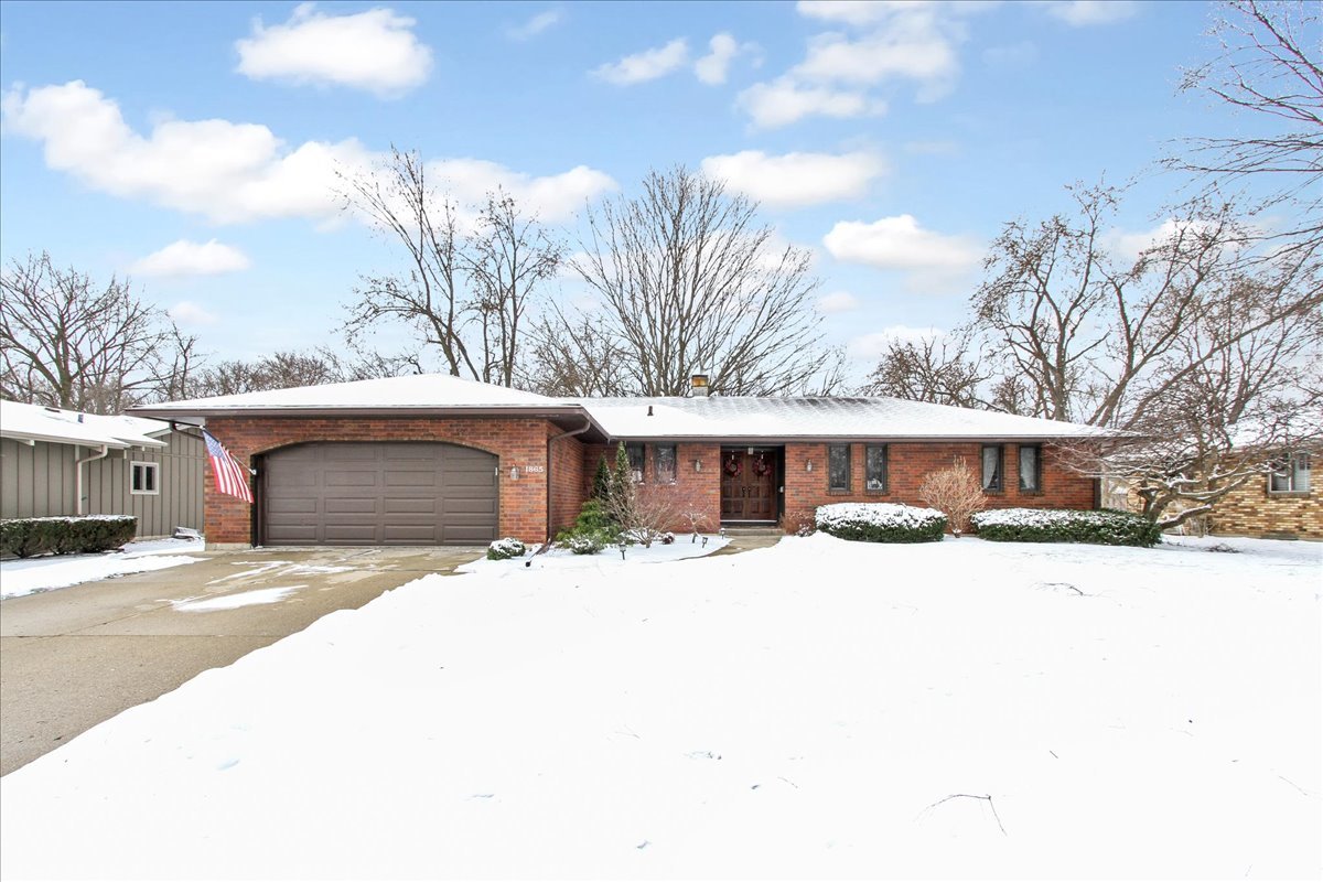 1865 Kevin Avenue Elgin, IL 60123 - Photo 4 of 48 a front view of a house with a yard covered in snow